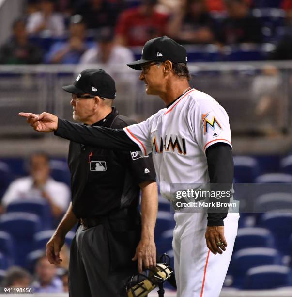 Don Mattingly of the Miami Marlins questions the umpire in the ninth inning during the game against the Boston Red Sox at Marlins Park on April 2,...