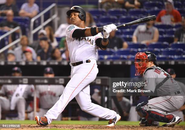 Starlin Castro of the Miami Marlins drives in an RBI in the ninth inning during the game against the Boston Red Sox at Marlins Park on April 2, 2018...