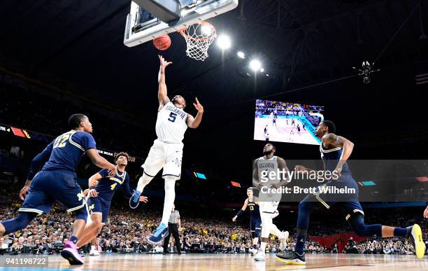 Phil Booth of the Villanova Wildcats drives to the basket against the Michigan Wolverines during the first half of the 2018 NCAA Photos via Getty...