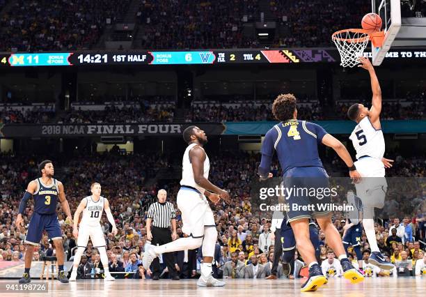 Phil Booth of the Villanova Wildcats drives to the basket against the Michigan Wolverines during the first half of the 2018 NCAA Photos via Getty...