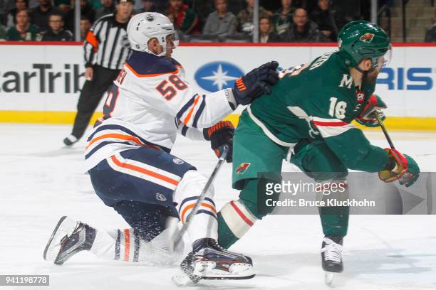 Anton Slepyshev of the Edmonton Oilers defends Jason Zucker of the Minnesota Wild during the game at the Xcel Energy Center on April 2, 2018 in St....