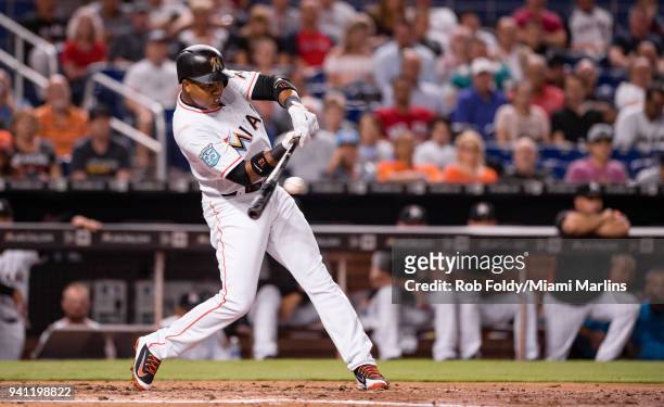 Starlin Castro of the Miami Marlins hits a single during the third inning of the game against the Boston Red Sox at Marlins Park on April 2, 2018 in...