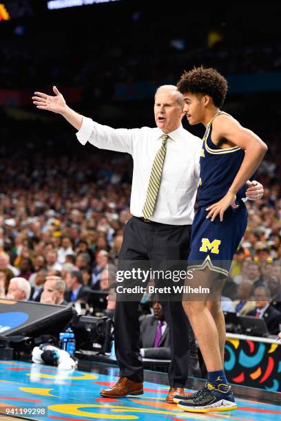 Head coach John Beilein of the Michigan Wolverines talks with Jordan Poole during the second half of the 2018 NCAA Photos via Getty Images Men's...