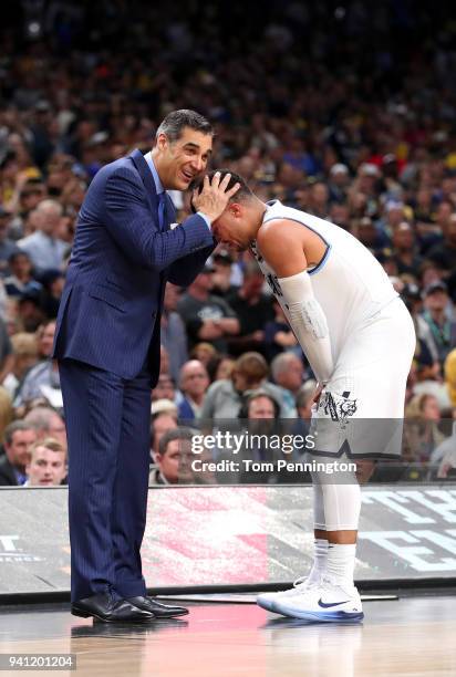 Head coach Jay Wright of the Villanova Wildcats celebrates with Jalen Brunson late in the second half against the Michigan Wolverines during the 2018...