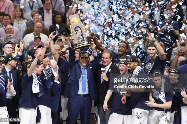 Head coach Jay Wright of the Villanova Wildcats raises the trophy with his team after defeating the Michigan Wolverines during the 2018 NCAA Men's...