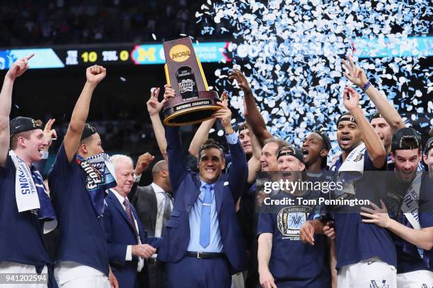 Head coach Jay Wright of the Villanova Wildcats raises the trophy with his team after defeating the Michigan Wolverines during the 2018 NCAA Men's...