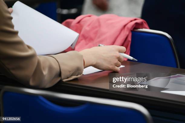 Student attends the inaugural class by Seiko Noda, Japan's internal affairs and communications minister, not pictured, at her school for female...