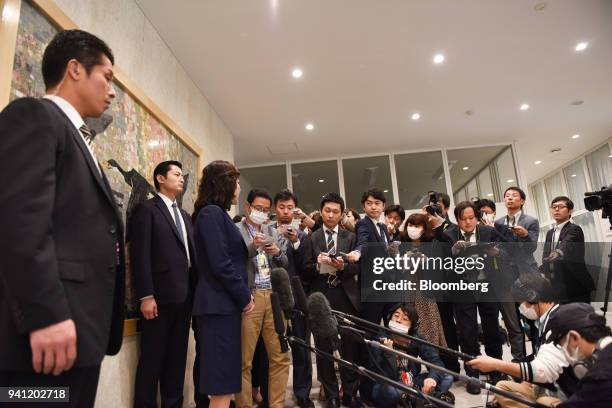 Seiko Noda, Japan's internal affairs and communications minister, third left, speaks to members of the media at the opening day of her school for...