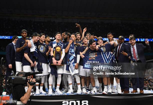 Donte DiVincenzo of the Villanova Wildcats holds the trophy on stage after the 2018 NCAA Photos via Getty Images Men's Final Four National...