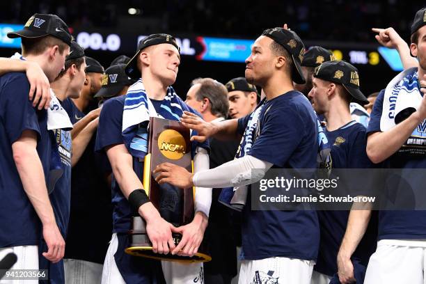 Donte DiVincenzo and Jalen Brunson of the Villanova Wildcats celebrate wiuth the trophy after the 2018 NCAA Photos via Getty Images Men's Final Four...