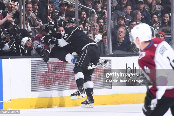 Christian Folin of the Los Angeles Kings bodychecks Matt Nieto of the Colorado Avalanche at STAPLES Center on April 2, 2018 in Los Angeles,...