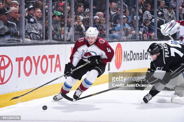 Tyson Barrie of the Colorado Avalanche handles the puck against Tanner Pearson of the Los Angeles Kings at STAPLES Center on April 2, 2018 in Los...