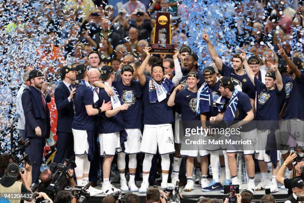 Jalen Brunson of the Villanova Wildcats holds the trophy after the 2018 NCAA Photos via Getty Images Men's Final Four National Championship game...