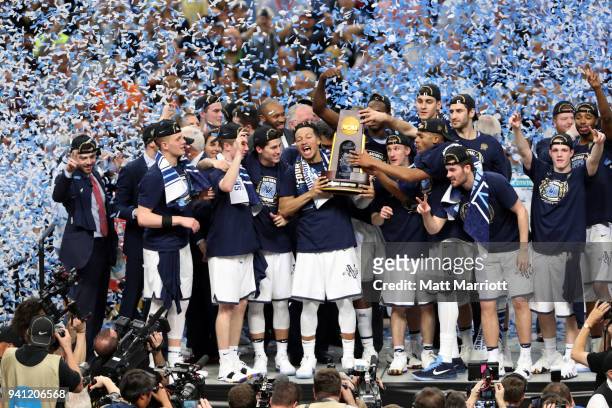 Jalen Brunson of the Villanova Wildcats holds the trophy after the 2018 NCAA Photos via Getty Images Men's Final Four National Championship game...