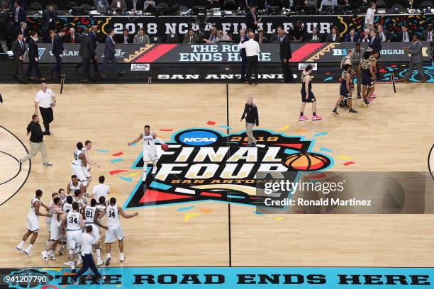 The Villanova Wildcats celebrate as the Michigan Wolverines walk off the court during the 2018 NCAA Men's Final Four National Championship game at...