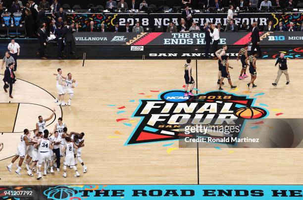 The Villanova Wildcats celebrate as the Michigan Wolverines walk off the court during the 2018 NCAA Men's Final Four National Championship game at...