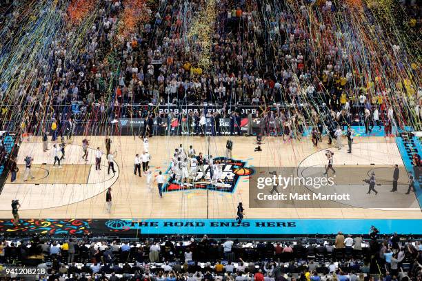 Confetti falls on the court after the 2018 NCAA Photos via Getty Images Men's Final Four National Championship game between the Michigan Wolverines...
