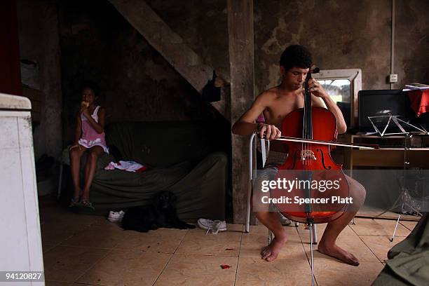 Felipe de Souza Ramos practices the cello in the concrete home he shares with six members of his family in recently 'pacified' Santa Marta, one of...