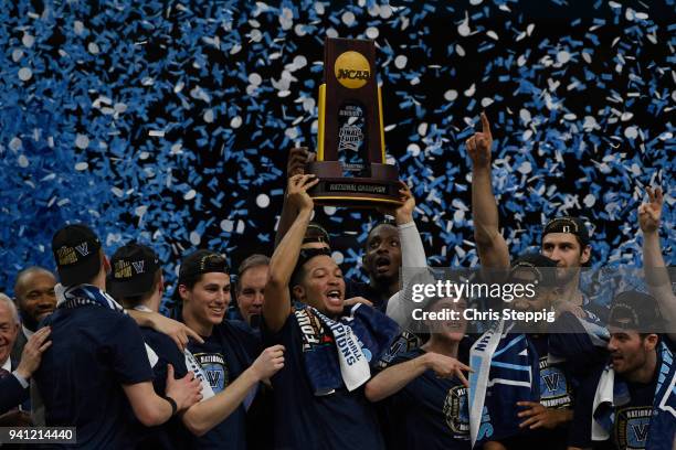 Jalen Brunson of the Villanova Wildcats holds up the trophy after the 2018 NCAA Photos via Getty Images Men's Final Four National Championship game...