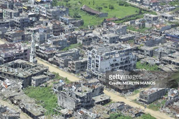 In this photo taken on March 28, 2018 shows an aerial shot of bombed-out houses in Marawi City, in southern island of Mindanao, after five months of...