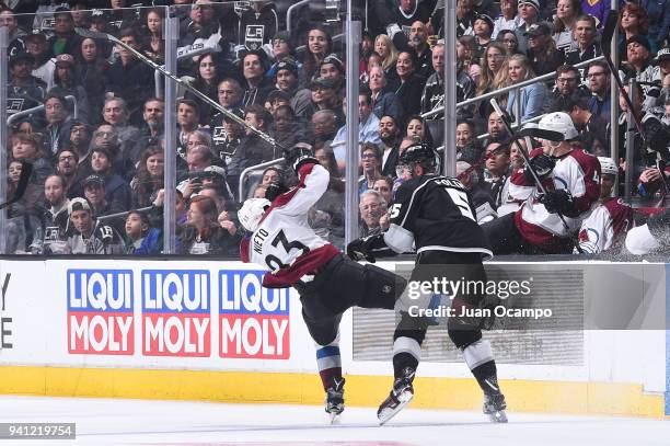Christian Folin of the Los Angeles Kings battles for the puck against Matt Nieto of the Colorado Avalanche at STAPLES Center on April 2, 2018 in Los...
