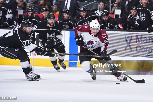 Matt Nieto of the Colorado Avalanche handles the puck against Jeff Carter of the Los Angeles Kings at STAPLES Center on April 2, 2018 in Los Angeles,...