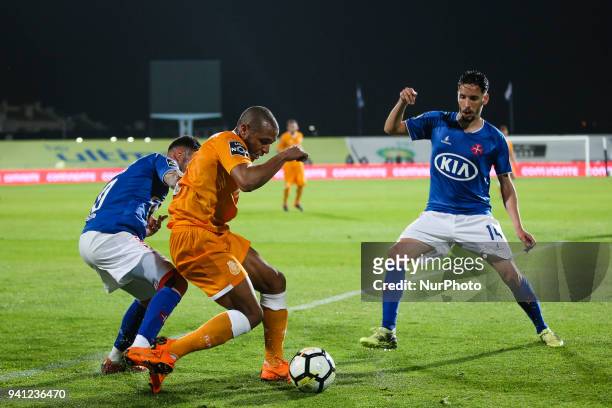 Porto's midfielder Yacine Brahimi vies with Belenenses's forward Diogo Viana and Belenenses's forward Lica during the Portuguese League football...
