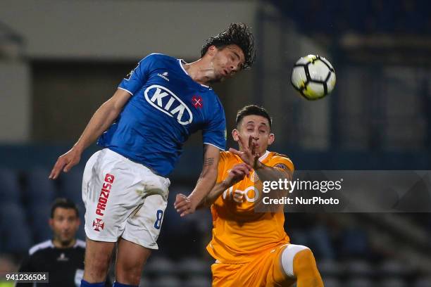 Porto's midfielder Hector Herrera vies with Belenenses's midfielder Marko Bakic during the Portuguese League football match between Belenenses and FC...