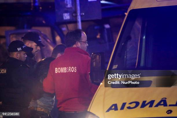 Medical team and the Police officers attend an injured man in the end of the Portuguese League football match between Belenenses and FC Porto at...