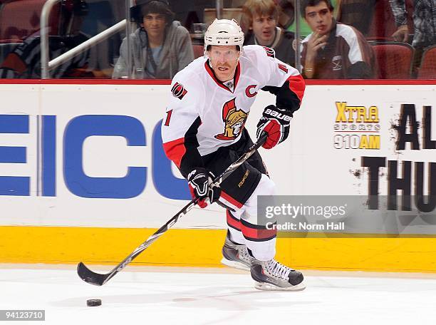 Daniel Alfredsson of the Ottawa Senators skates the puck up ice against the Phoenix Coyotes on December 5, 2009 at Jobing.com Arena in Glendale,...