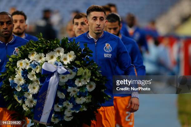 Porto Midfielder Hector Herrera from Mexico deliver a crown of flowers moments before the Portuguese League football match between CF Os Belenenses v...
