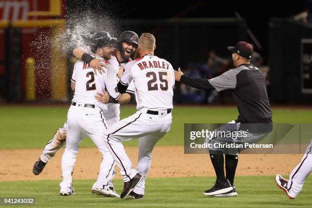 Jeff Mathis of the Arizona Diamondbacks is congratulated by Alex Avila and Archie Bradley after a walk-off single to defeat the Los Angeles Dodgers...