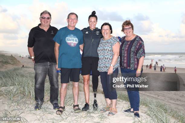 Sophie Pascoe of New Zealand poses with her parents Gary and Jo Pascoe and other family members on the beach after being named as New Zealand's flag...