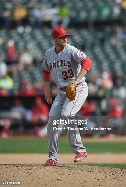 Jim Johnson of the Los Angeles Angels of Anaheim pitches against the Oakland Athletics in the bottom of the eighth inning at Oakland Alameda Coliseum...