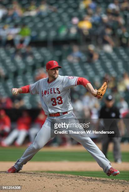 Jim Johnson of the Los Angeles Angels of Anaheim pitches against the Oakland Athletics in the bottom of the eighth inning at Oakland Alameda Coliseum...