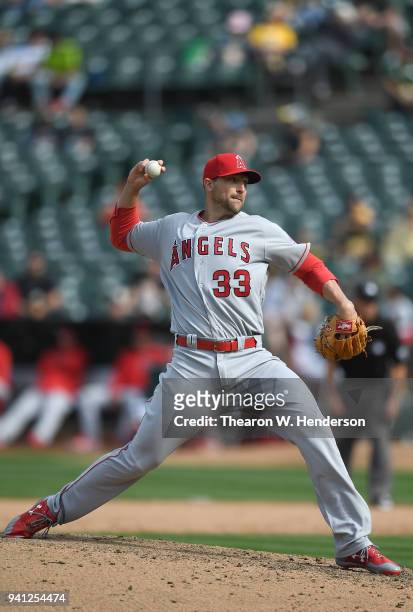 Jim Johnson of the Los Angeles Angels of Anaheim pitches against the Oakland Athletics in the bottom of the eighth inning at Oakland Alameda Coliseum...