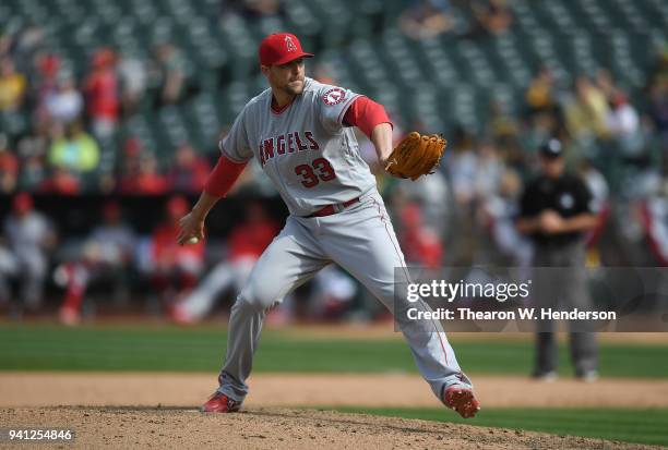 Jim Johnson of the Los Angeles Angels of Anaheim pitches against the Oakland Athletics in the bottom of the eighth inning at Oakland Alameda Coliseum...