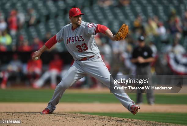 Jim Johnson of the Los Angeles Angels of Anaheim pitches against the Oakland Athletics in the bottom of the eighth inning at Oakland Alameda Coliseum...