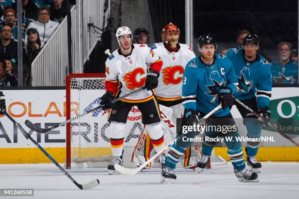 Joe Pavelski and Evander Kane of the San Jose Sharks set up in front of the net against Travis Hamonic and David Rittich of the Calgary Flames at SAP...