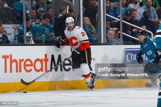 Travis Hamonic of the Calgary Flames skates with the puck against the San Jose Sharks at SAP Center on March 24, 2018 in San Jose, California. Travis...