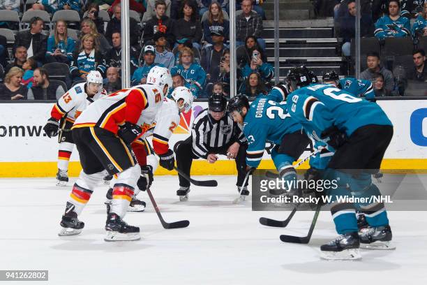 Nick Shore of the Calgary Flames faces off against Barclay Goodrow of the San Jose Sharks at SAP Center on March 24, 2018 in San Jose, California....