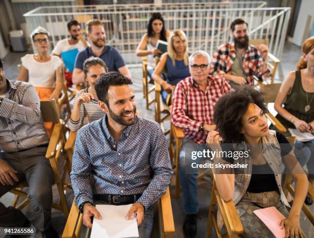 large group of happy business people attending a seminar. - men and women in a large group listening stock pictures, royalty-free photos & images