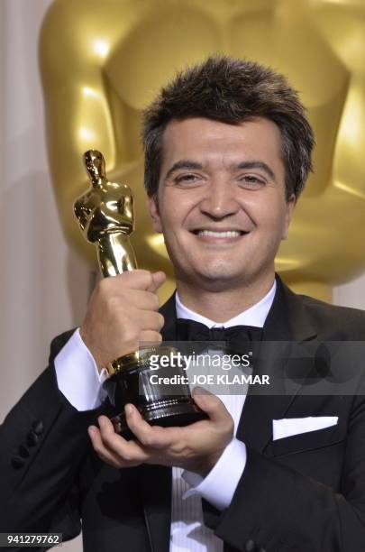 Producer for "The Artist," Thomas Langmann poses with his trophy in the press room at the 84th Annual Academy Awards on February 26, 2012 in...