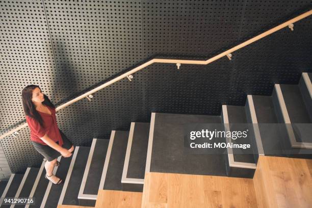 a mature caucasian woman is going up the stairs - photohui17 bildbanksfoton och bilder
