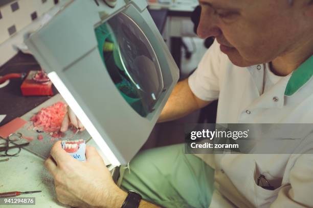 mid adult man making a dental prosthesis - acrylic fiber stock pictures, royalty-free photos & images