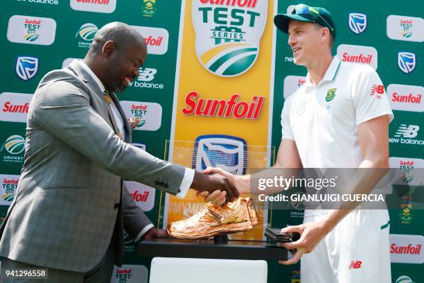 South African bowler Morne Morkel receives a trophy as he played his last match in Test Cricket after winning the fifth Test cricket match between...