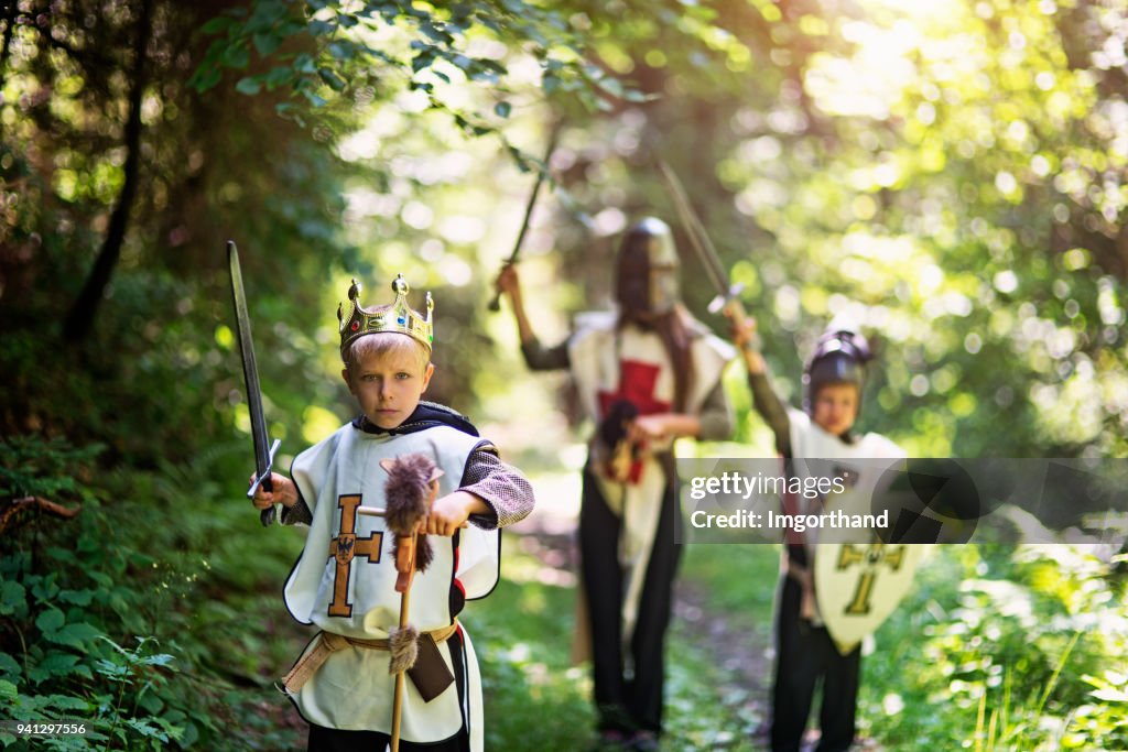 Kids playing knights in forest