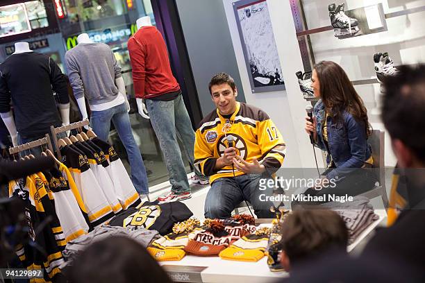 Milan Lucic, left wing for the Boston Bruins, is interviewed by NHL.com's Carrie Milbank during a question and answer session at the NHL Store on...
