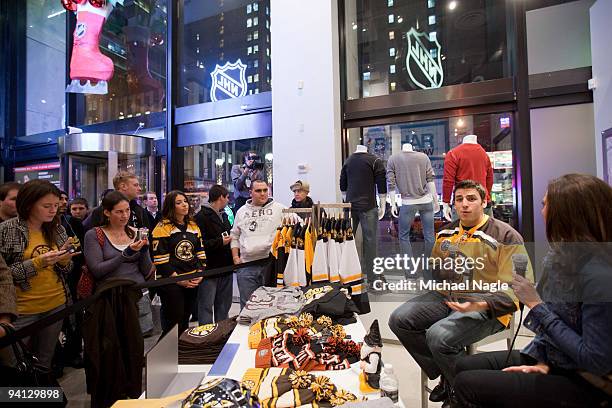 Milan Lucic, left wing for the Boston Bruins, is interviewed by NHL.com's Carrie Milbank during a question and answer session at the NHL Store on...