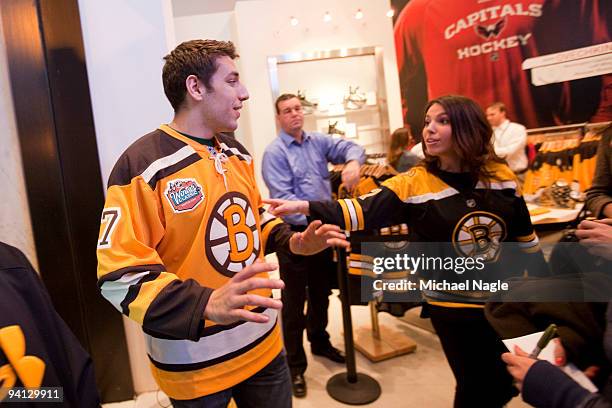 Milan Lucic, left wing for the Boston Bruins, speaks with fans after a question and answer session at the NHL Store on December 7, 2009 in New York...